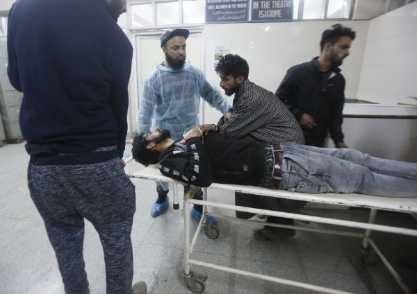 Kashmiri men wheel in civilian