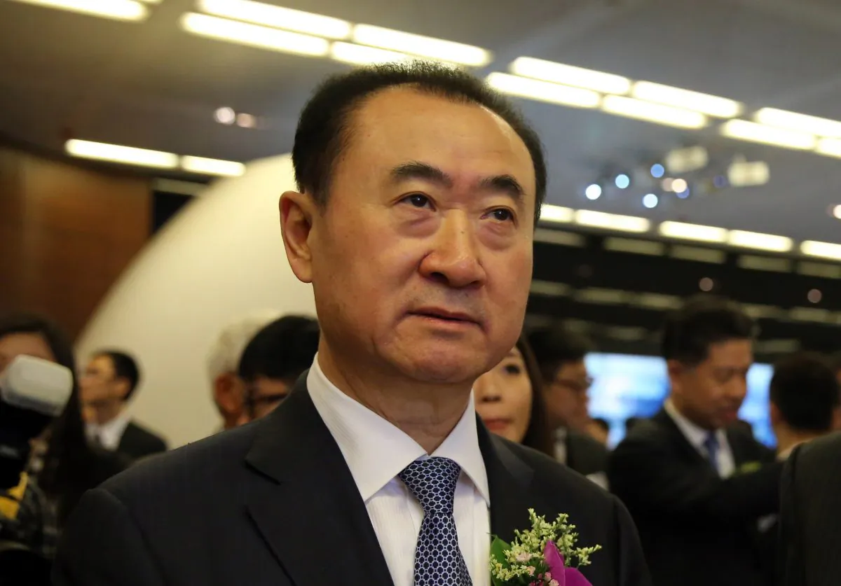 Wang Jianlin (C), CEO of Dalian Wanda Commercial Properties Co. arrives for the company's IPO at the Hong Kong stock exchange on December 23, 2014. (Isaac Lawrence/AFP/Getty Images)