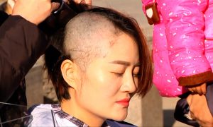 Wife Shaves Head to Protest Detention of Rights Lawyer Husband