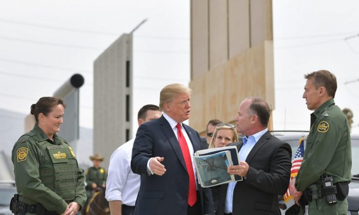 President Donald Trump (C) is shown border wall prototypes in San Diego, California on March 13, 2018. (Mandel Ngan/AFP/Getty Images)