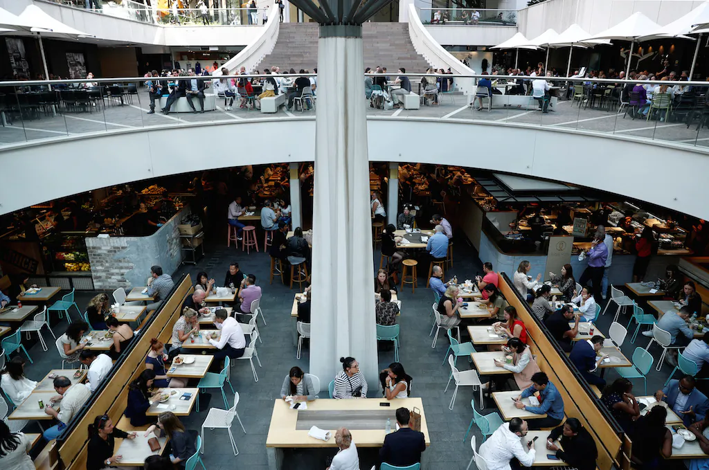 Office workers take their lunch at a food court in Sydney, Australia, May 4, 2018. (Edgar Su/File Photo/Reuters)
