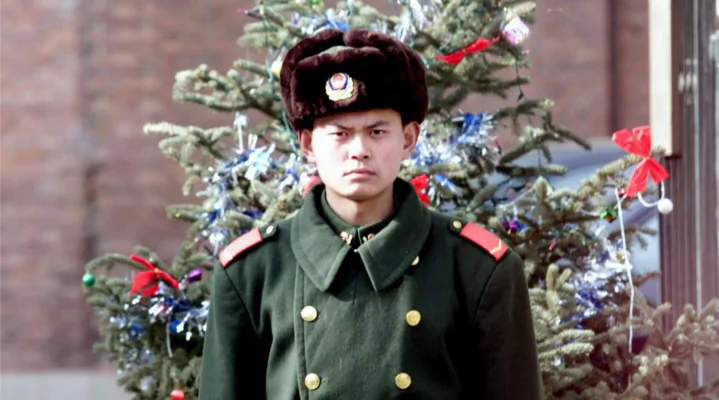 A Chinese People's Armed policeman stands guard in front of a Christmas tree outside a diplomatic compound in Beijing 21, China on Dec. 2000. (Goh Chai Hin/AFP/Getty Images)
