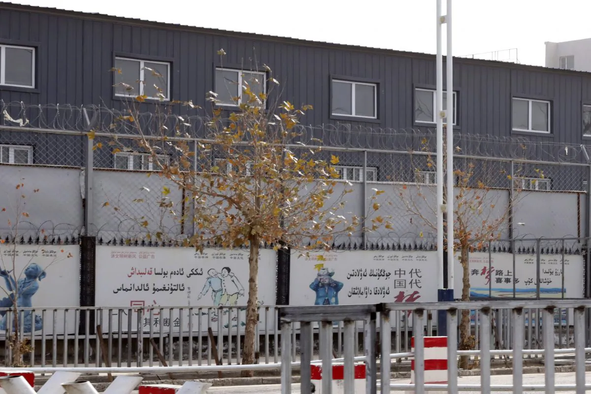 Two layers of barbed wire fencing surround the "Hotan City apparel employment training base" where Hetian Taida has a factory in Hotan in Xinjiang, China, as seen on Dec. 5, 2018. (Ng Han Guan/AP)
