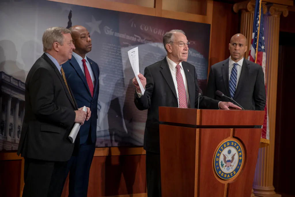 Sen. Dick Durbin (D-IL) and Sen. Corry Booker (D-N.J.) listen to Senate Judiciary Committee Chairman Chuck Grassley (R-IA) speak on the passage of the First Step Act on Dec. 19, 2018, in Washington. (Tasos Katopodis/Getty Images)