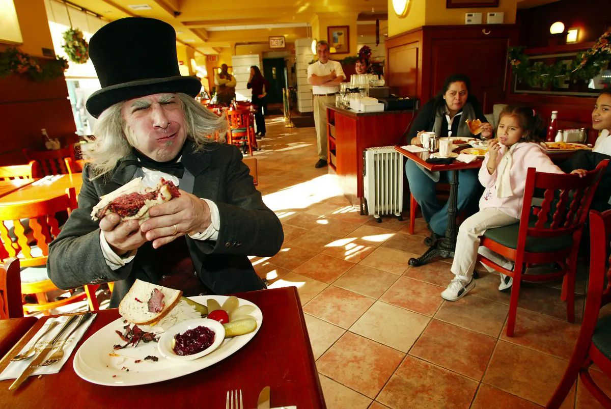 Ebenezer Scrooge from Radio City Entertainment's "A Christmas Carol" creates and enjoys the "Scrooge Sandwich" at the Stage Door Deli in New York City. (Scott Gries/ImageDirect)