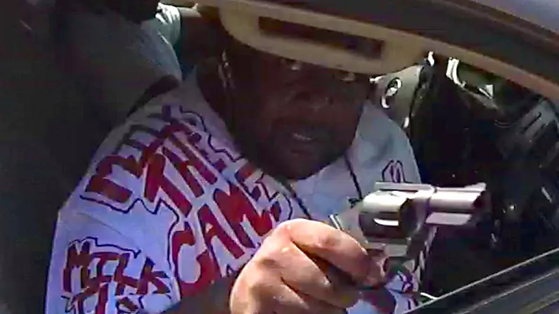 This photo from an Omaha police officer’s body camera shows John Ezell Jr. aiming his pistol out the car window during the incident in which Ezell, and Officer Ken Fortune, were shot. (Omaha Police Department)
