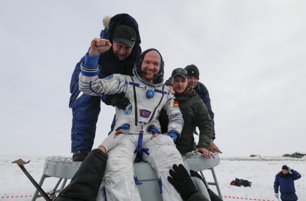 Ground personnel help International Space Station crew member Alexander Gerst of Germany to get out of the Soyuz MS-09 capsule