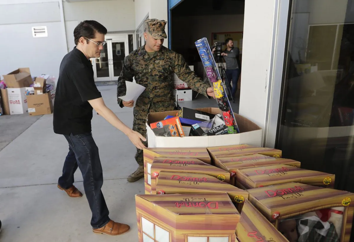 Sgt. Christian Pastrana, right, prepares toys for a donation to the organization Women in Distress, at the Marine Corps Toys for Tots depot in Hialeah, Fla., on Dec. 19, 2018. (Lynne Sladky/AP Photo)

