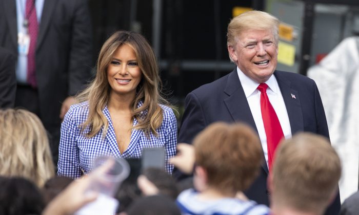 President Donald Trump and First Lady Melania Trump greet guests during a picnic for military families at the White House, on July 4, 2018. (Alex Edelman/Getty Images)