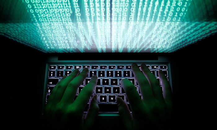 A man types on a computer keyboard in Warsaw on Feb. 28, 2013. (Kacper Pempel/Reuters)