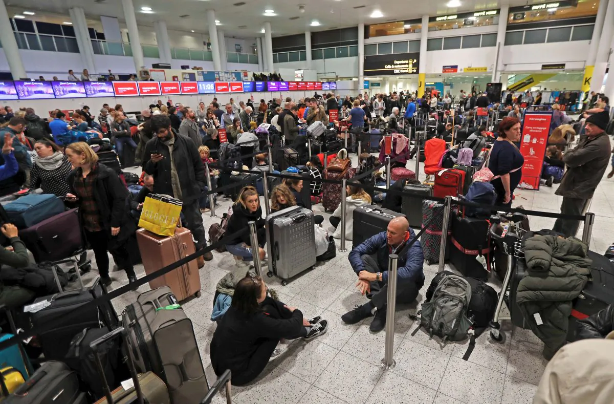 Passengers wait around in the South Terminal building at Gatwick Airport after drones flying illegally over the airfield forced the closure of the airport on Dec. 20, 2018. (Reuters/Peter Nicholls)