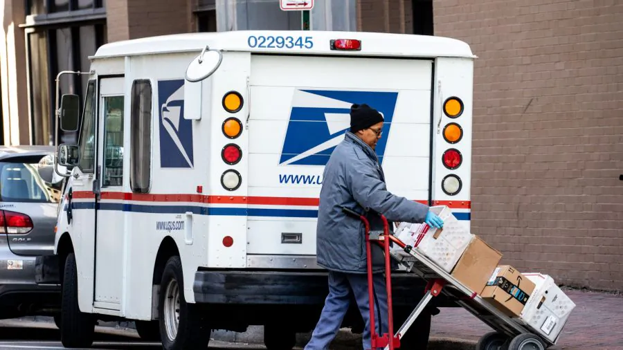 A woman unloads a USPS truck in Norfolk, Va., on Jan. 26, 2018. (Samira Bouaou/The Epoch Times)