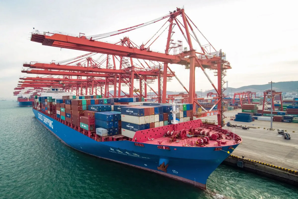 A cargo ship docks at port in Qingdao, Shandong province on Dec. 8. China's export growth slowed last month weighed down by slowing global demand and trade tensions with the United States. (STR/AFP/Getty Images)