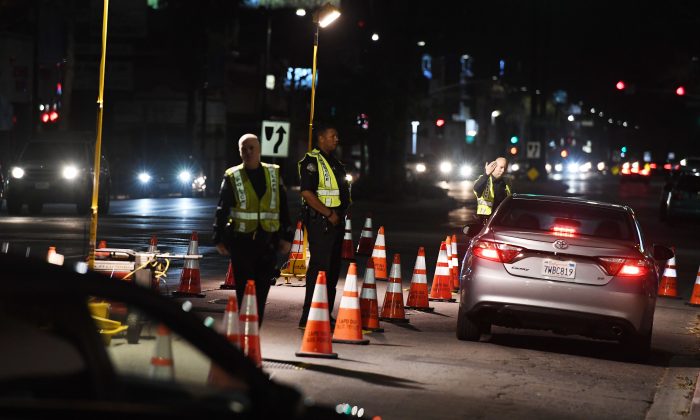 LAPD officers check drivers at a DUI checkpoint in Reseda, Los Angeles, Calif., on April 13, 2018.  (Mark Ralston/AFP/Getty Images)