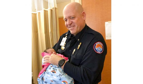 Paramedic Mickey Huber holds 2-day-old baby Zoele Mickey Skinner