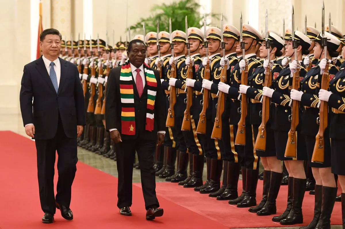 Zimbabwean President Emmerson Mnangagwa reviews a military honor guard with Chinese leader Xi Jinping during a welcoming ceremony at the Great Hall of the People in Beijing on April 3, 2018. (Greg Baker/AFP/Getty Images)