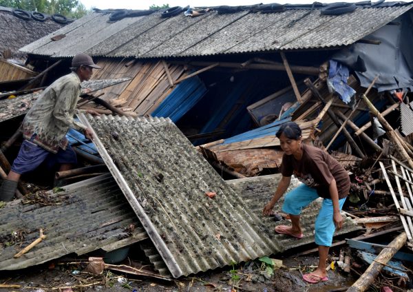 residents collect debris after tsunami