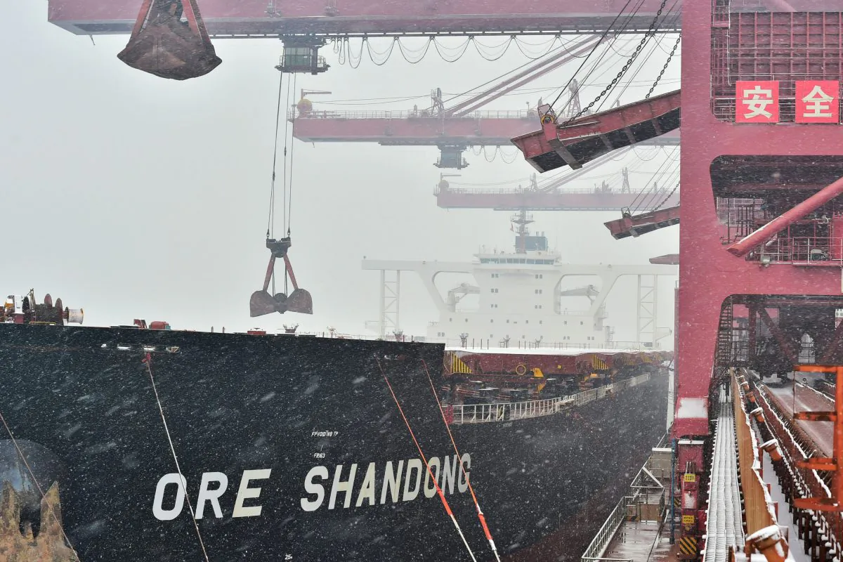 Cranes unload imported iron ore from a ship to the iron ore terminal at Qingdao Port in Shandong Province, China, on Dec. 11, 2018. (Reuters/Stringer)
