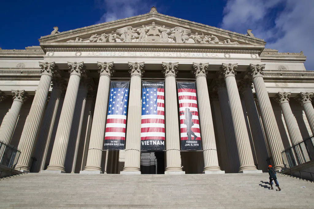 People walk up the steps to the National Archives in Washington on Dec. 22, 2018. (Alex Brandon/AP)