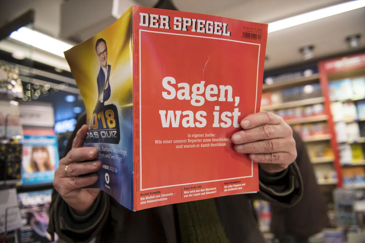 A man looks into the latest issue of German newsweekly Der Spiegel with a cover page that reads, "To say, what is" in Cologne, Germany, on Dec. 22, 2018. (Thomas Lohnes/Getty Images)