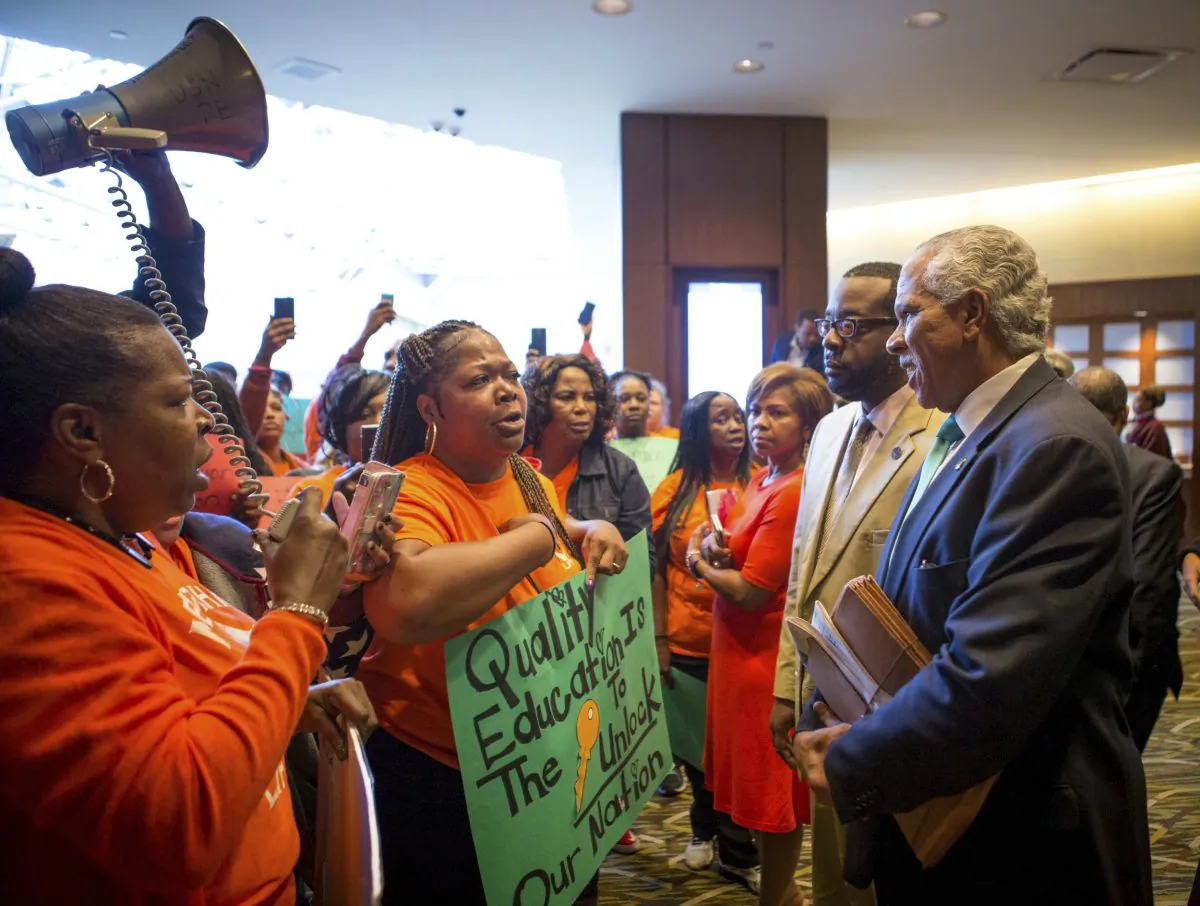 Parents and grandparents from Memphis Lift speak to Hilary Shelton, the Director to the NAACP's Washington Bureau and Senior Vice President for Advocacy and Policy, during the national NAACP board meeting in downtown Cincinnati on Oct. 15, 2016. (The Cincinnati Enquirer via AP)