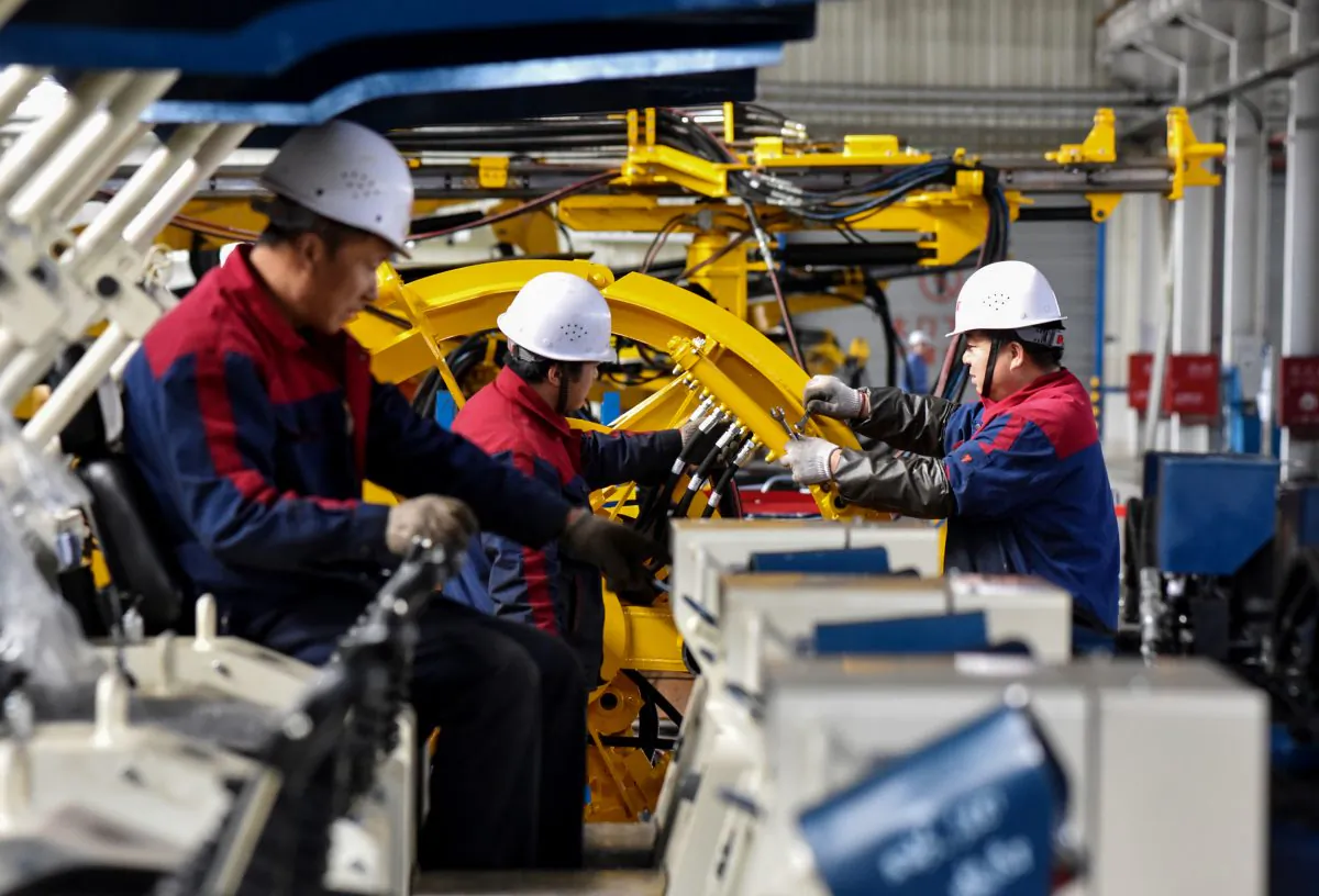 Employees work on a drilling machine production line at a factory in Zhangjiakou in China’s northern Hebei Province on Nov. 14, 2018. (STR/AFP/Getty Images)
