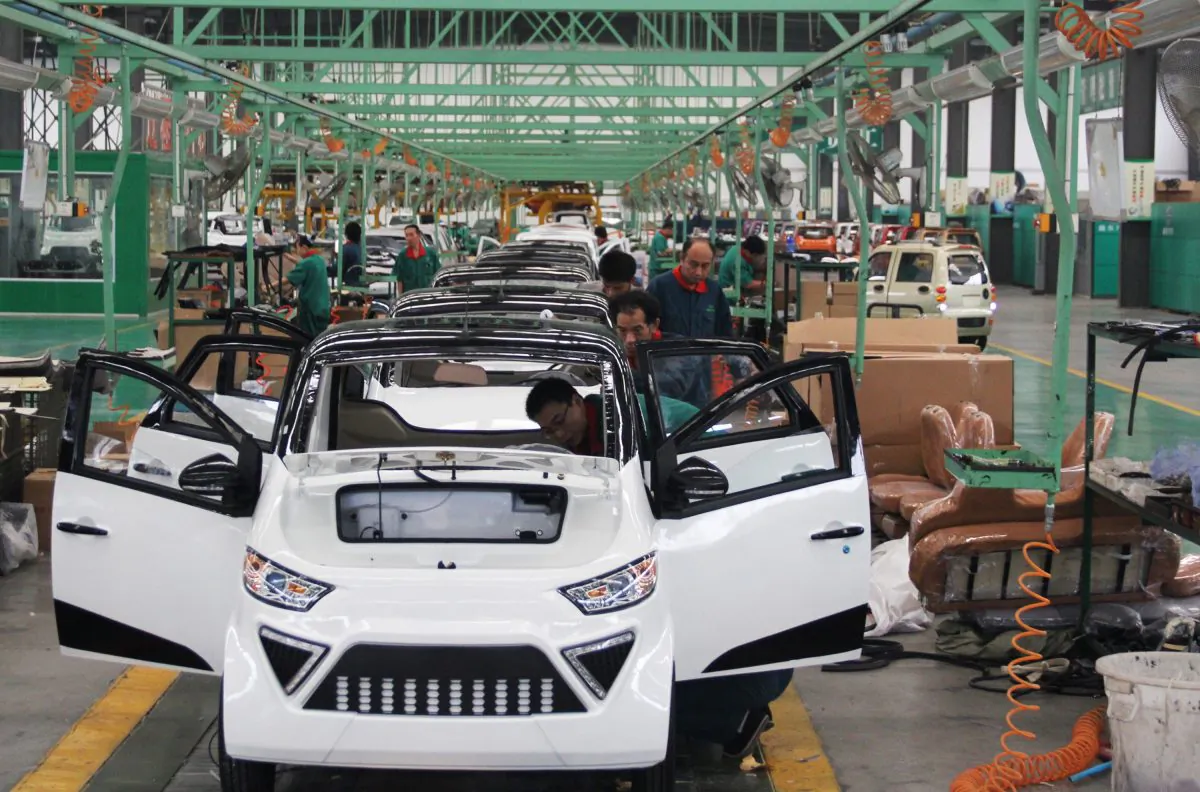Workers assemble electric cars at a factory in Zouping City, Shandong Province in eastern China, on September 16, 2014. (AFP/AFP/Getty Images)