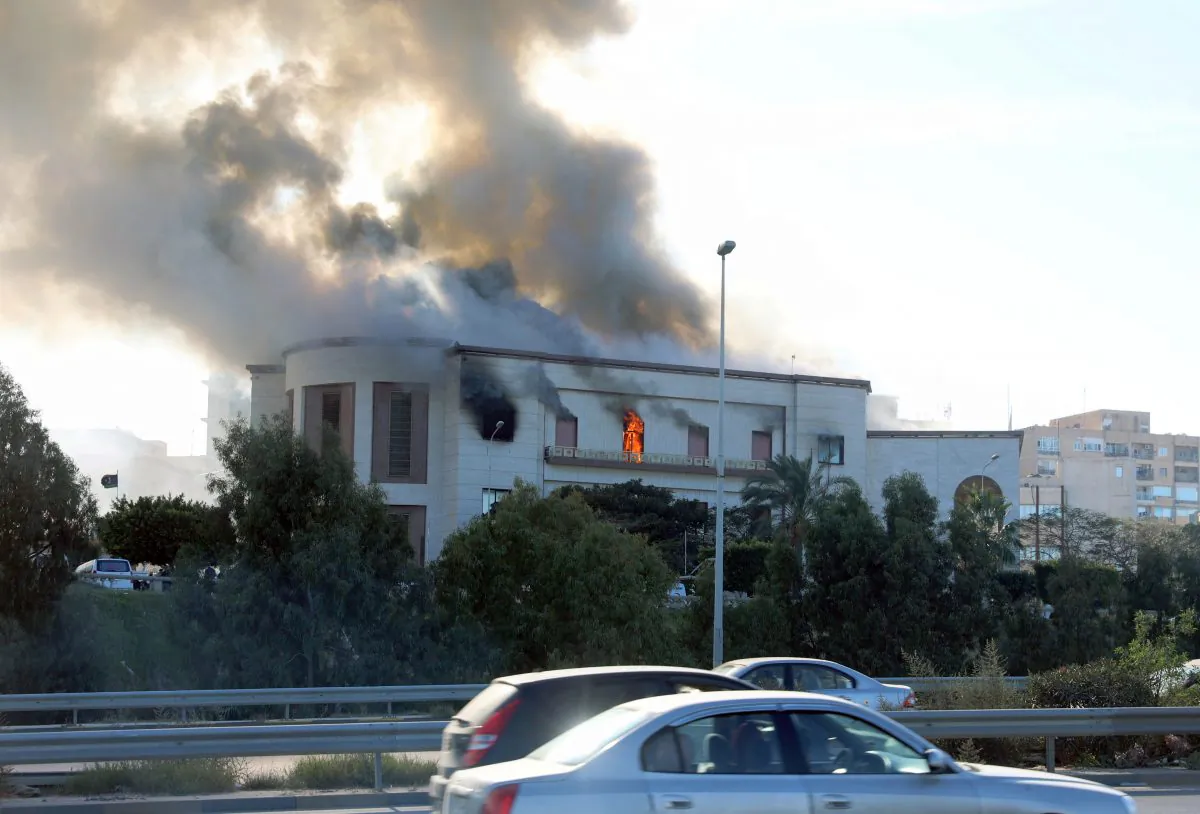 Smoke rises from the site of the headquarters of Libya's foreign ministry after suicide attackers hit in Tripoli, Libya, Dec. 25, 2018. (Reuters/Hani Amara)