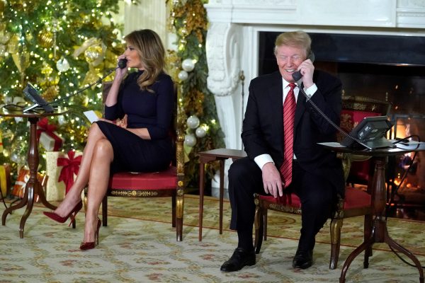 President Trump and the first lady participate in NORAD Santa tracker phone calls from children, in the State Dining Room of the White House in Washington