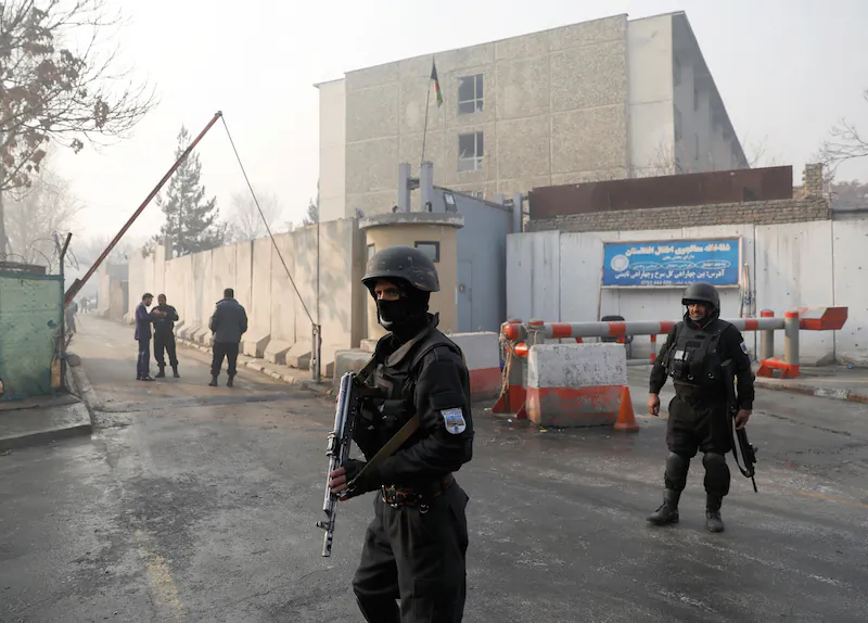 File—Afghan policemen outside a government compound in Kabul that was hit by an attack on Dec. 25, 2018. The Jan. 20, 2019, car bomb blast on a highway near Kabul targeted a convoy, killing at least eight Afghan security force members. (Mohammad Ismail/Reuters)