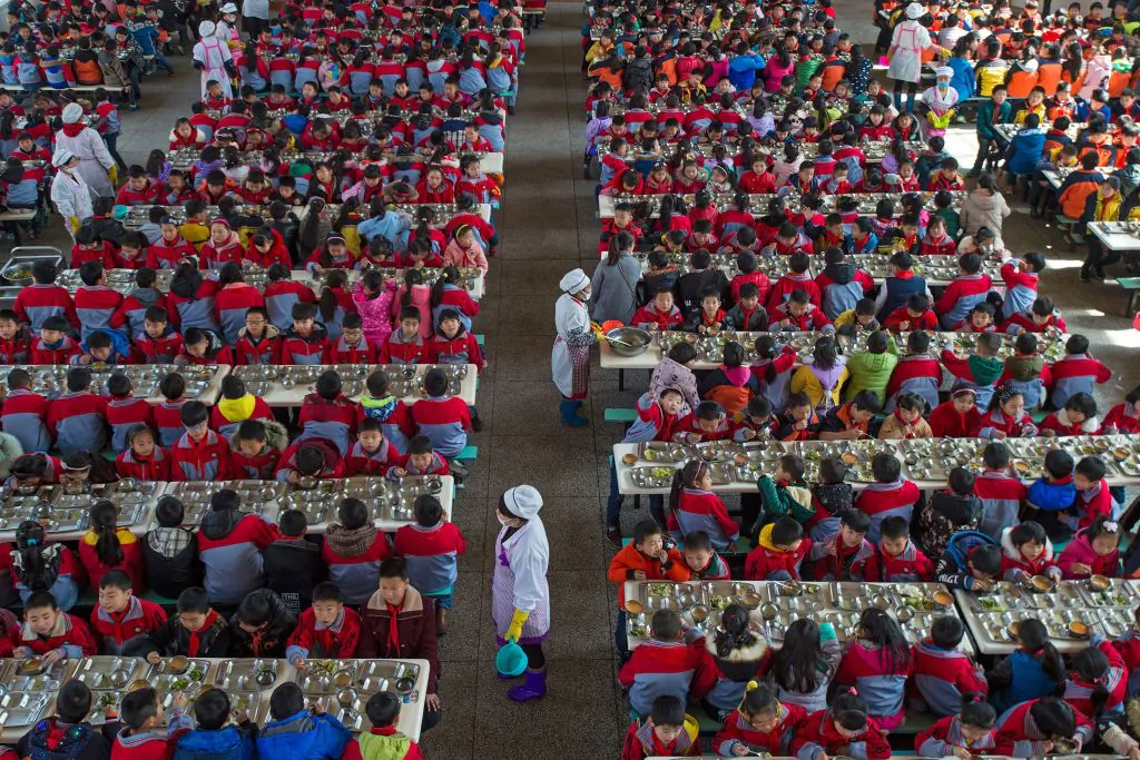 Children eat their meal at a primary school in Wuhan in central China's Hubei Province, on Feb. 27, 2017. (STR/AFP/Getty Images)