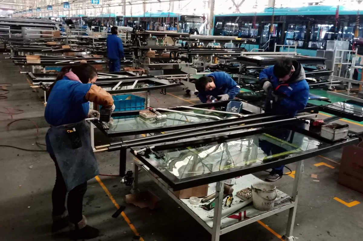 Chinese workers build parts for an electric bus at a factory in Liaocheng, Shandong Province, on Dec. 12, 2018. (STR/AFP/Getty Images)