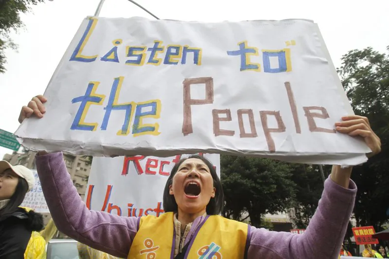 A protester shouts slogans demanding tax reform outside the Ministry of Finance in Taipei, Taiwan, on Dec. 27, 2018. (AP Photo/Chiang Ying-ying)