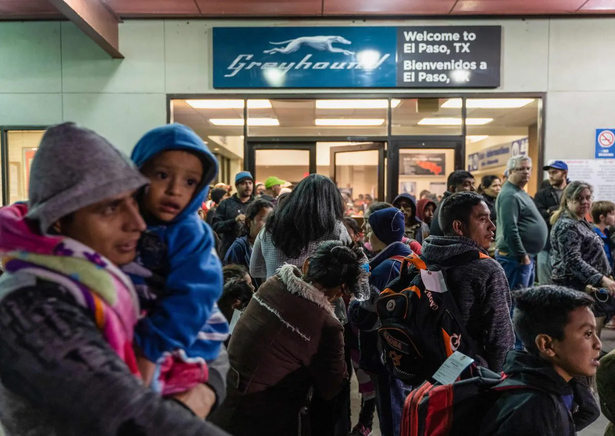 Asylum-seekers wait at a Greyhound bus station  in El Paso, Texas, after being dropped off by Immigration and Customs Enforcement, on Dec. 23, 2018. (PAUL RATJE/AFP/Getty Images)