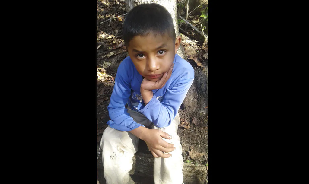 This Dec, 12, 2018 photo provided by Catarina Gomez on Dec. 27, 2018, shows her half-brother Felipe Gomez Alonzo, 8, near her home in Yalambojoch, Guatemala.  (Catarina Gomez via AP)