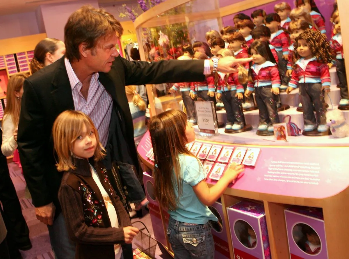 Actor Harry Hamlin shows his daughters the doll display in Los Angeles, on April 21, 2006. (Kevin Winter/Getty Images)