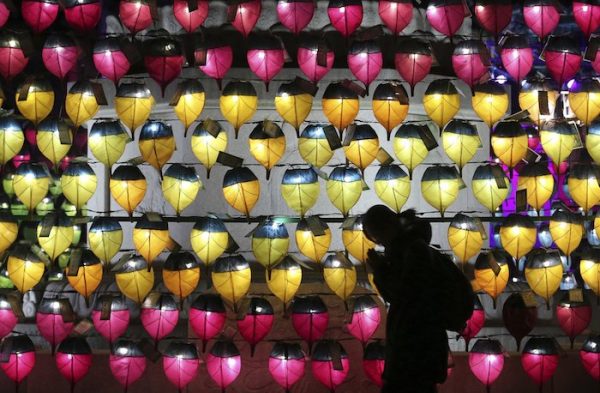 A woman prays at the Jogyesa Buddhist temple in Seoul, South Korea, (AP Photo/Ahn Young-joon)