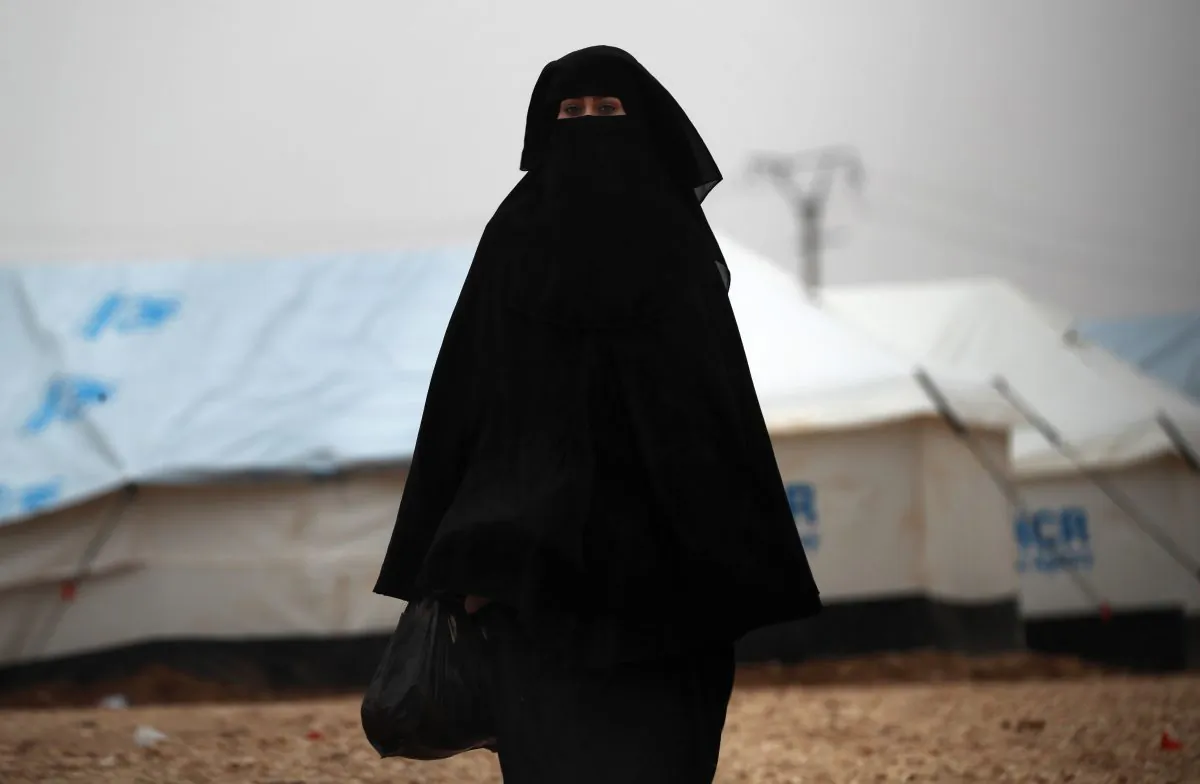 A fully veiled woman walks at the camp of al-Hol in al-Hasakeh governorate in northeastern Syria on Dec. 17, 2018.(Delil Souleiman/AFP)