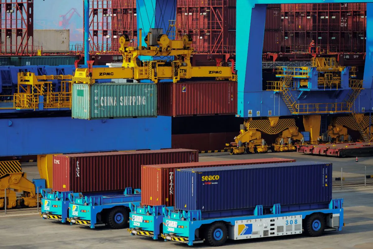Driverless trucks transferring containers at an automated cargo wharf in Qingdao City, Shandong Province, China, on Oct. 24, 2018. (STR/AFP/Getty Images)
