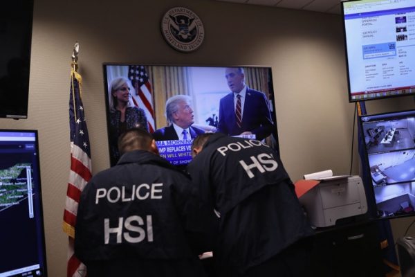 Homeland Security Investigations ICE agents work in control center.