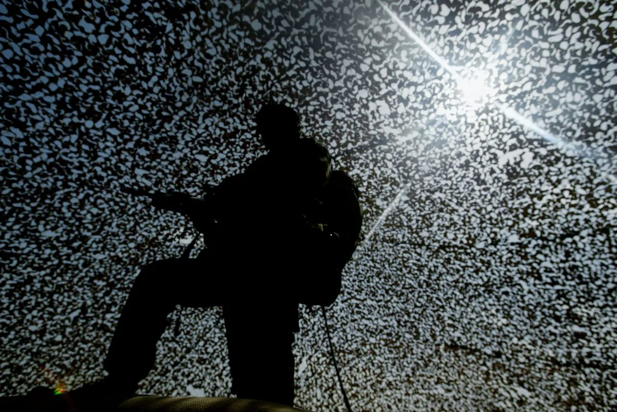 A British soldier stands under camouflage netting, near Kuwait City in 2003. (Ian Waldie/Getty Images)