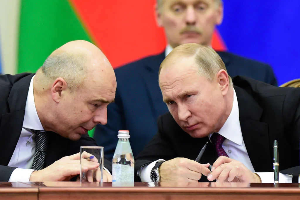 Russian President Vladimir Putin (R) and Finance Minister Anton Siluanov chat during a meeting of the Supreme Eurasian Economic Council in Saint Petersburg on Dec. 6, 2018. (Olga Maltseva/AFP/Getty Images)