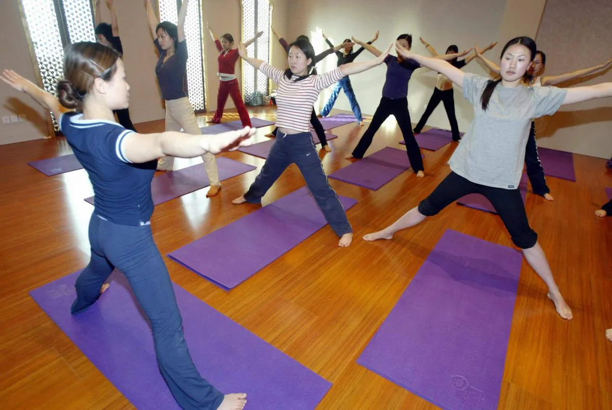 A group of Chinese women workout at a yoga class in Beijing 02 March 2005.  (STR/AFP/Getty Images)