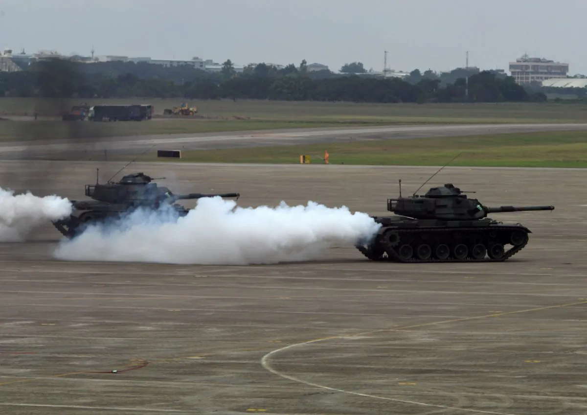 Two M60A3 tanks release smoke during the Han Kuang drill at the Ching Chuan Kang (CCK) air force base in Taichung, central Taiwan, on June 7, 2018. (SAM YEH/AFP/Getty Images)