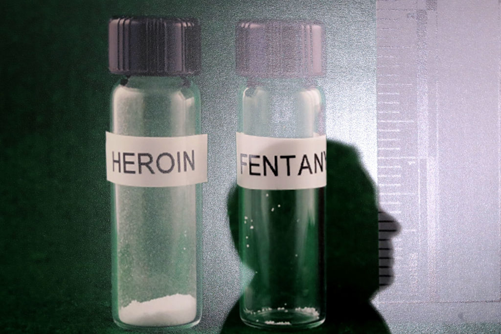 The shadow of Sen. Lindsey Graham (R-SC) is cast on a photograph of heroin and fentanyl