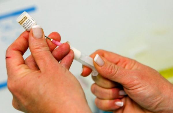 A nurse prepares a vaccine