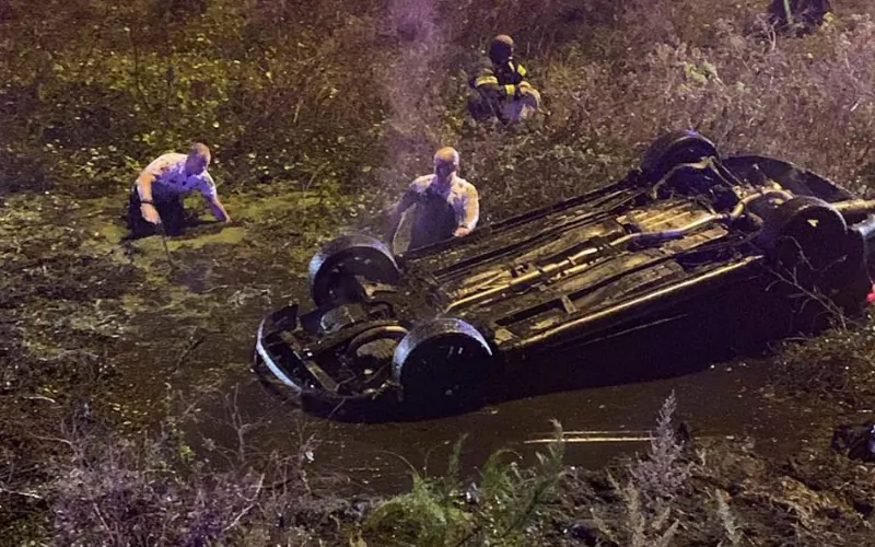 Deputies wade out to an overturned car near the I-4 highway in Florida, on Jan. 1, 2019. (Hillsborough County Sheriff)