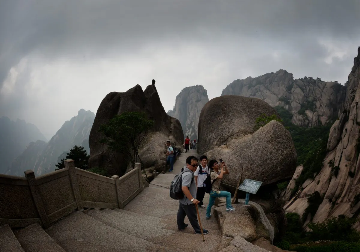 Chinese tourists hiking on Lotus Peak which is the most revered of the Huangshan (Yellow Mountains) peaks at the park in Anhui Province.  The UNESCO World Heritage Site is one of China's major tourist destinations and has been a source of inspiration to Chinese painters, writers and poets for thousands of years. (Mark Ralston/AFP/Getty Images)
