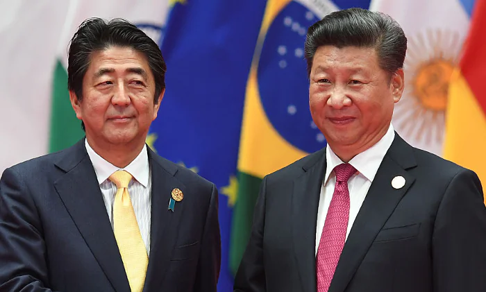 Japan's Prime Minister Shinzo Abe (L) shakes hands with Chinese leader Xi Jinping (R) before the G20 leaders' family photo in Hangzhou on Sept. 4, 2016. (Greg Baker/AFP/Getty Images)