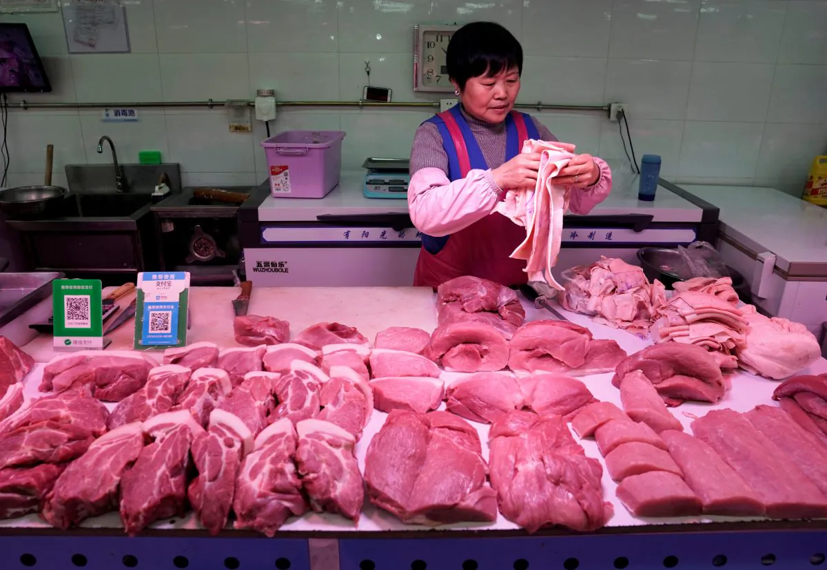A vendor collects the pigskin at a market in Beijing on Dec. 26, 2018. (Jason Lee/Reuters)